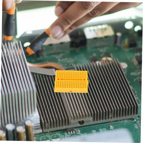 Plug And Play Solderless Breadboard Kit With Six Compact Yellow Protoboard Panels For Rapid Circuit Assembly on a motherboard.