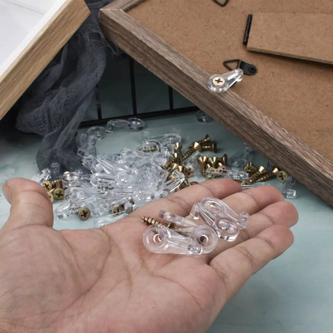 Top Tier 50 Pack Cabinet Glass Retainer Clips And Gold Screw Kit For Easy Door Installation and Rock Solid Home Setup shown in hand.
