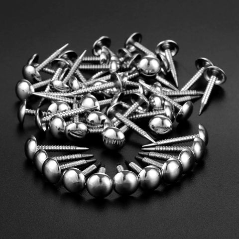 Kick Your Home Decor Up A Notch With These Legit Tough Vintage Silver Upholstery Nails 100 Piece Zinc Alloy Furniture Tacks scattered on a dark surface.