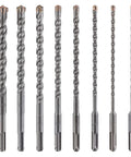 Nine carbide-tipped concrete drill bits with twisted flutes and 3/8-inch shanks, arranged in a row