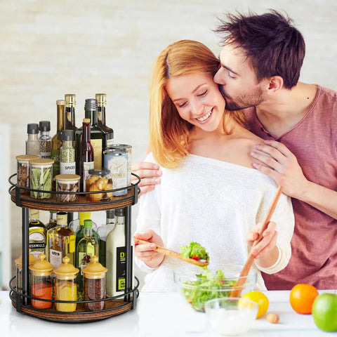 Rotating Spice Rack Two Tier Lazy Susan Organizer with bottles and jars on kitchen counter, couple preparing salad nearby