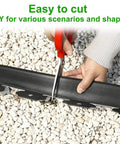 Person cutting Two Inch Tall Garden Edging Kit With 100 Feet Of Border And 120 Spikes, Plastic Landscape Edging For Lawn