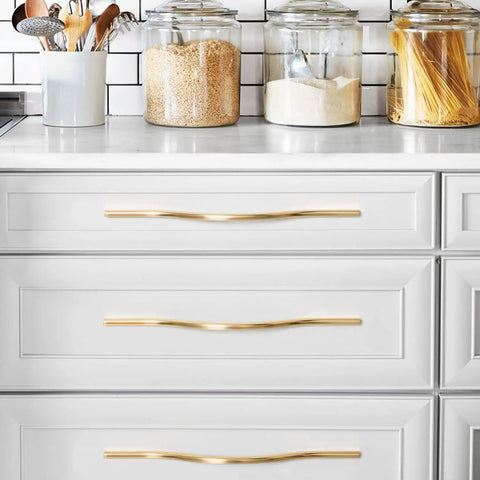 Low Profile Brushed Brass Cabinet Pulls Set With Double Hole Centers For Drawers And Wardrobes shown on white kitchen drawers