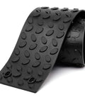 Non Slip Outdoor Stair Treads 4x24 Inch Diamond Textured Rubber Mats for Steps, coiled black rubber strip showing texture detail