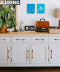 Adjustable Wood Cabinet Hardware Handles Pack Of 6 Unfinished DIY Pulls installed on white cabinet drawers with decor items on top.