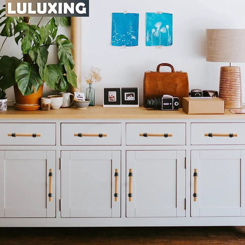 Adjustable Wood Cabinet Hardware Handles Pack Of 6 Unfinished DIY Pulls installed on white cabinet drawers with decor items on top.