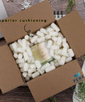 Hassle Free Biodegradable Corn Starch Packing Peanuts Bulk For Moving And Shipping inside a cardboard box, cushioning a glass bottle.
