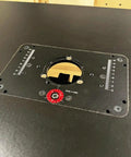 Close-up of Built Tough Router Lift Table featuring precise depth control gauge and sturdy mounting holes for wood projects.