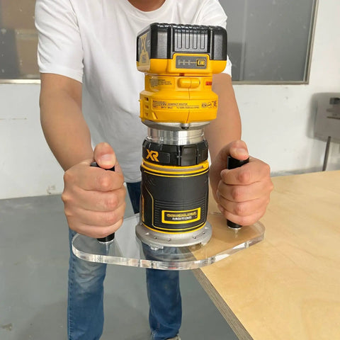 Professional Router Base Plate Compatible With Dwp611 And Dcw600b Routers; showing hands gripping router on clear acrylic platform.