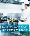 Chefs working in a commercial kitchen with stainless steel equipment and visible hood, illustrating efficiency and performance.