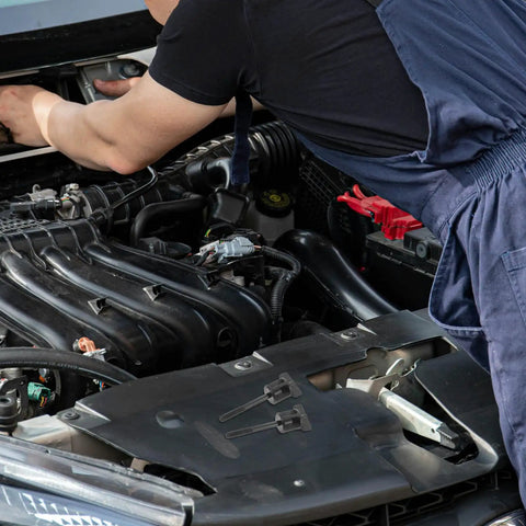 Mechanic installing heavy duty spare tire retention bolt and wheel mounting screw lock nut for Civic engine bay