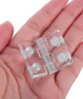 Beefy Frosted Acrylic Cabinet Door Hinge With Pre Drilled Holes in a hand showing size and clear material
