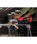 Heavy Duty 4.5 Inch Cordless Circular Saw With Brushless Motor Punching Up To 4500 Rpm cutting wood on a saw horse in a workshop.