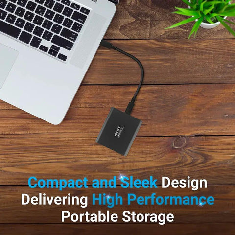 Pro Elite V2 1TB USB 3.2 Gen 2x1 Type-C External SSD For Gamers And Creators, Ultra Fast 1100 MB Per Second Read, 1000 MB Per Second Write, shown on wooden desk with laptop