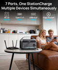 Living room with Your Go To Portable Power Station With 60W Solar Panel Included 288Wh LiFePO4 Battery 350W Continuous 600W Peak 7 Port Design Fast Charge For Home Backup And Outdoor Camping on table connecting devices, couple seated on sofa using phone