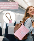 Woman on airplane with a pink Two In One Travel Blanket And Pillow Ultra Soft And Compact For Airplane Travel With Luggage Strap And Clip.