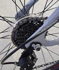 Close-up of 7 Speed Bicycle Freewheel TZ500 Screw On 14-28T installed on a bike hub, showcasing durable steel construction.