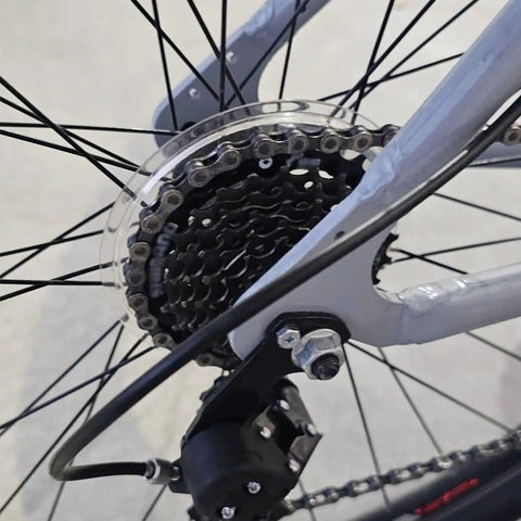 Close-up of 7 Speed Bicycle Freewheel TZ500 Screw On 14-28T installed on a bike hub, showcasing durable steel construction.