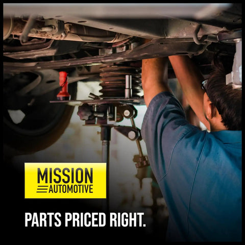 Mechanic working on vehicle undercarriage, Mission Automotive sign, parts priced right