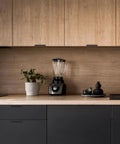 10 Pack Black Finger Edge Pulls For Cabinets And Drawers, installed in modern kitchen, showcasing matte black finish on wood cabinetry.
