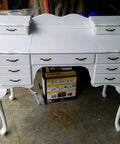 White desk with six drawers featuring antique brass arch style decorative pull handles