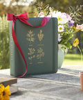 Big Capacity Seed Packet Organizer Binder With 50 Heavy Duty Sheet Protectors That Holds 200 Seed Envelopes, green, on table.