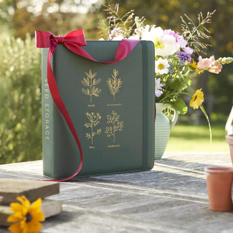 Big Capacity Seed Packet Organizer Binder With 50 Heavy Duty Sheet Protectors That Holds 200 Seed Envelopes, green, on table.