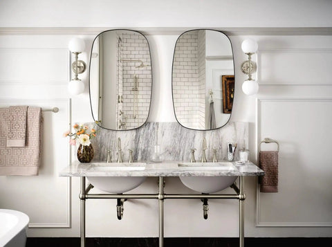 Bathroom with Colinet Traditional 24-Inch Towel Bar in Brushed Nickel, mounted near double vanity with mirrors.