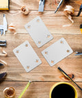 Flat Brackets Set, Stainless Steel Silver 30 Pieces for Wood Furniture on a workbench with tools and shavings.