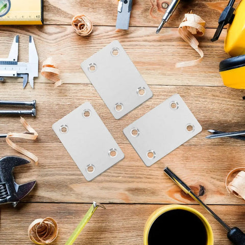 Flat Brackets Set, Stainless Steel Silver 30 Pieces for Wood Furniture on a workbench with tools and shavings.