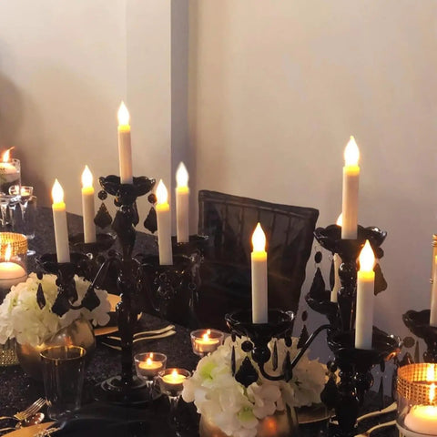 12 Pack Battery Operated Taper Candles With Remote, Warm White Flicker in elegant candelabras on a decorated table