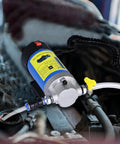 Smooth 12V Oil Extractor Pump For Quick Engine Oil Swaps With Self Priming Gear Mechanism and Suction Tubing in car engine bay.