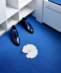 White Self Adhesive Sneaker Repair Patches For Fresh Kicks Instant Heel Hole Fix arranged near shiny blue dress shoes on a blue floor.