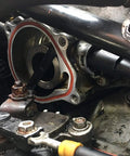 Front view of VW vacuum pump mounting flange with red gasket ring and exposed rotor.