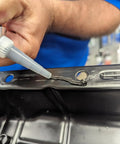 Applying Ultra Black RTV Silicone Gasket Maker for Maximum Oil Resistance, 10.6 Oz Cartridge on metal surface.