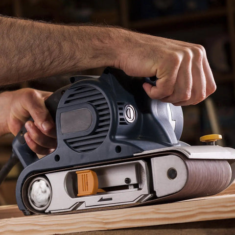 Man using Heavy Duty Sanding Belts 6X89 Inches One Twenty Grit Aluminum Oxide Abrasive Paper on wood with a belt sander.