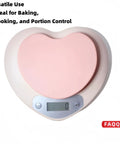 Heart-shaped digital kitchen scale with LCD display for baking, 11 lb capacity, pink finish.