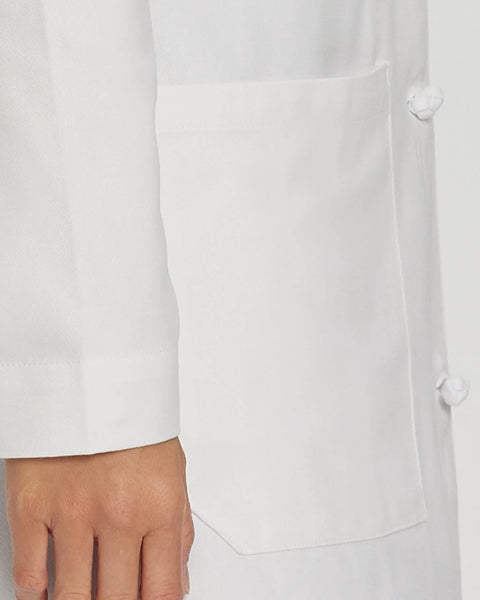 Close-up of a Womens Knot Button Lab Coat 36 And A Quarter Inch White Work Ready Scrub Coat With Fabric Knot Closure showing pocket and cuff.