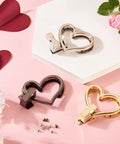 Three heart-shaped purse turn-lock closures set: silver, gunmetal, and gold with mounting screws
