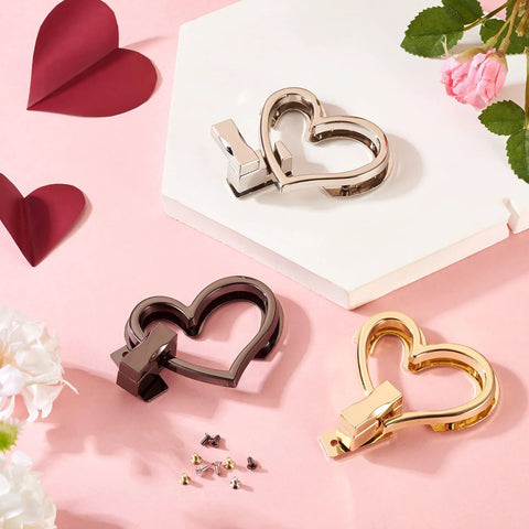 Three heart-shaped purse turn-lock closures set: silver, gunmetal, and gold with mounting screws