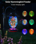 Solar Powered Hummingbird Feeder With 49 Fl Oz Capacity Hand Blown Blue Glass Color Changing Night Glow installed outdoors
