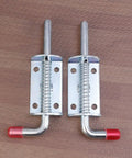 Spring Pin Latch Lock 2pcs for Utility Trailer Gate, Silver with spring-loaded design and red tips, top view on wooden background.