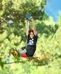 Child on a tree-mounted zipline cable using heavy duty five sixteenth inch galvanized steel zipline cable for backyard builds.