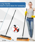 Image showing a woman standing with a Big 24 Inch Push Broom With 60 Inch Handle For Indoor Outdoor Cleaning in a garage or shop.