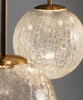 Close-up of Top Shelf Modern Crackle Glass Sphere Pendant Cluster Integrated Led Brass Finish, showcasing intricate glass texture.