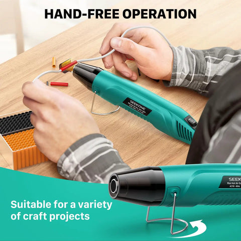 Mini 350W Heat Gun With Dual Temp 500F And 842F in use for craft projects with hands-free operation and reflector nozzle visible