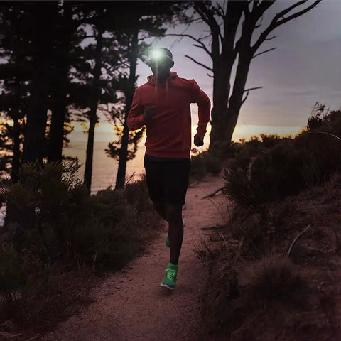 Runner on a forest trail at dusk, wearing Ultra Bright LED Headlamp Beast With Five Lighting Modes White And Red LEDs For Running Cycling Fishing Hiking Camping And Repairing IPX6 Waterproof Headlamp Beams Up To 262 Feet Lightweight 2.6 Oz With Batteries Included.