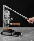 Top Shelf Manual Lever Espresso Maker Built From Heavy Duty 304 Stainless Steel with wood grip in use for homemade espresso.
