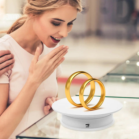 Awesome Electric Rotating Display Stand For Jewelry And Collectibles Featuring 360 Swivel Showcase With Adjustable Speed And Velvet White Base displaying gold rings.