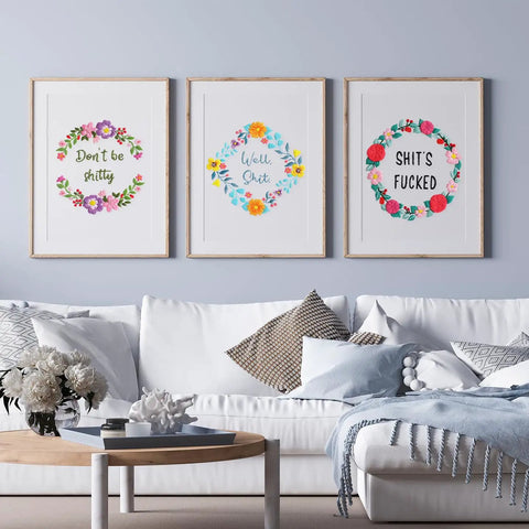 Living room with framed funny embroidery kits featuring flower wreath patterns and witty words, a part of three sets of funny embroidery kits